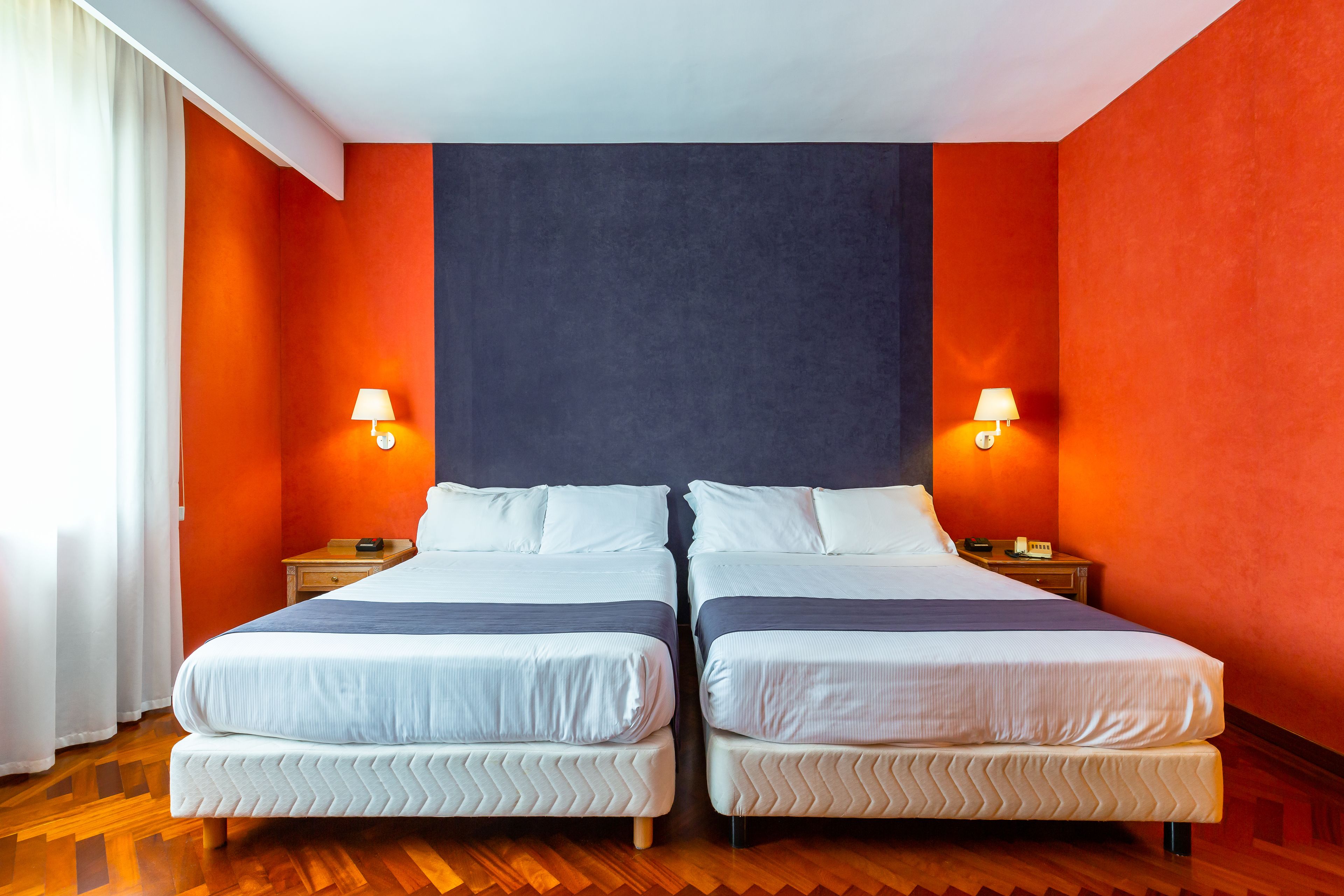 A double bed with a headboard, two bedside tables, and a nightstand.