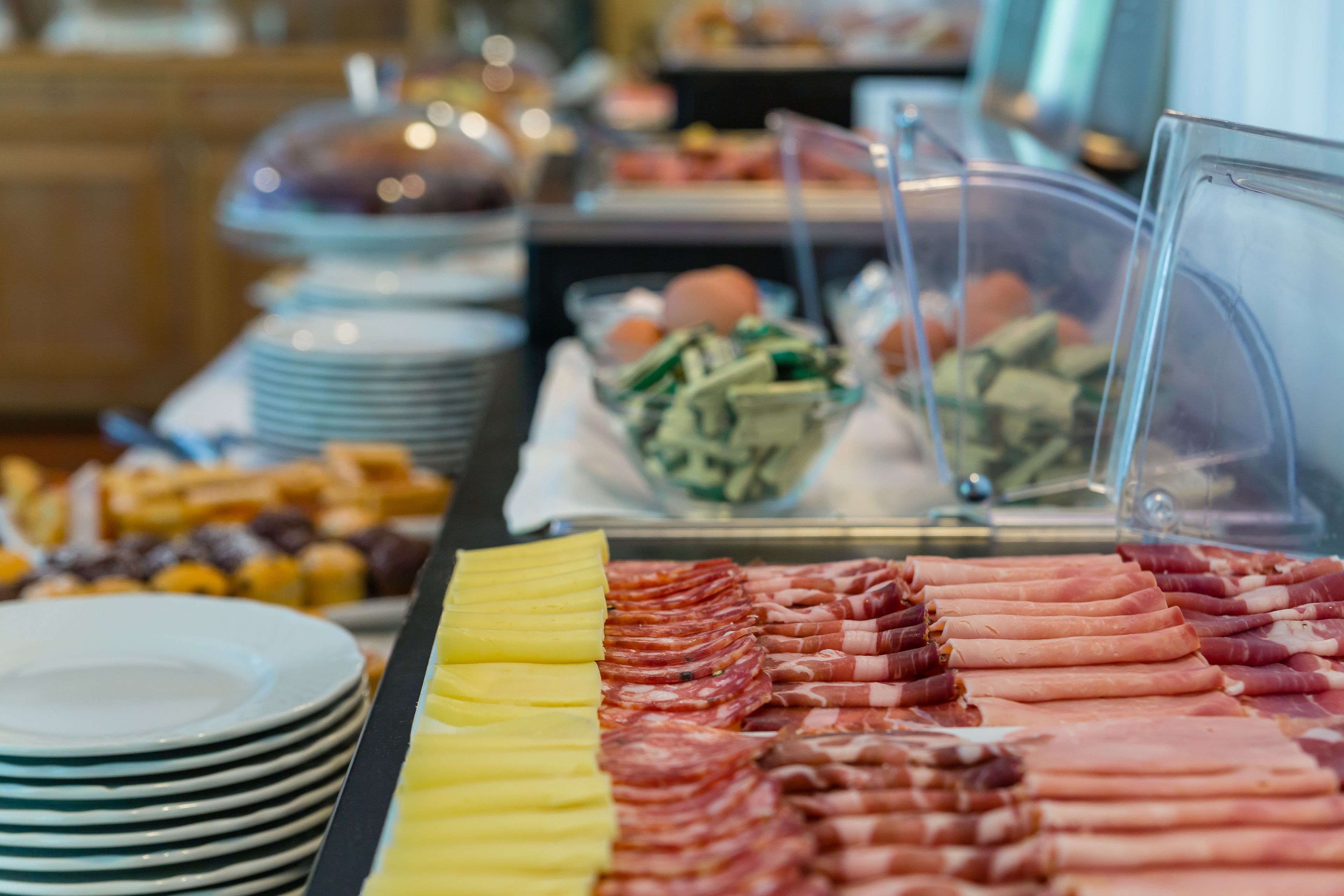 A buffet with various food items including meats and salads.