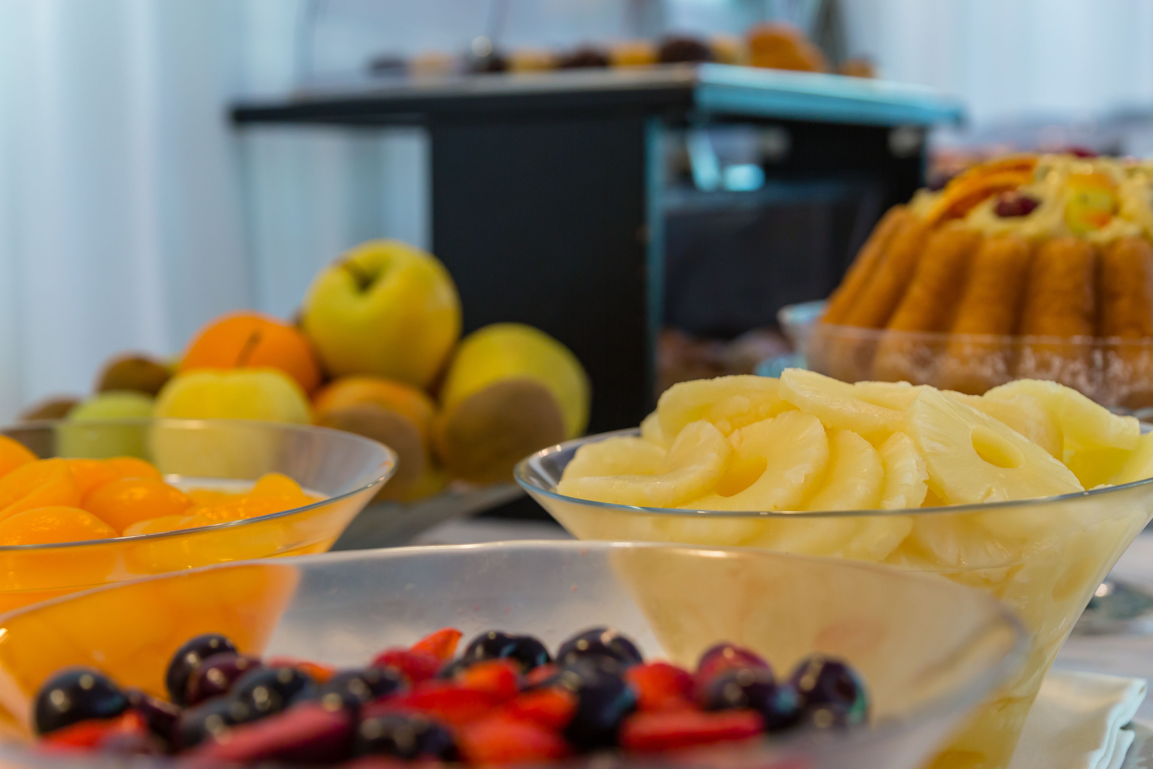 A buffet with various fruits and desserts.