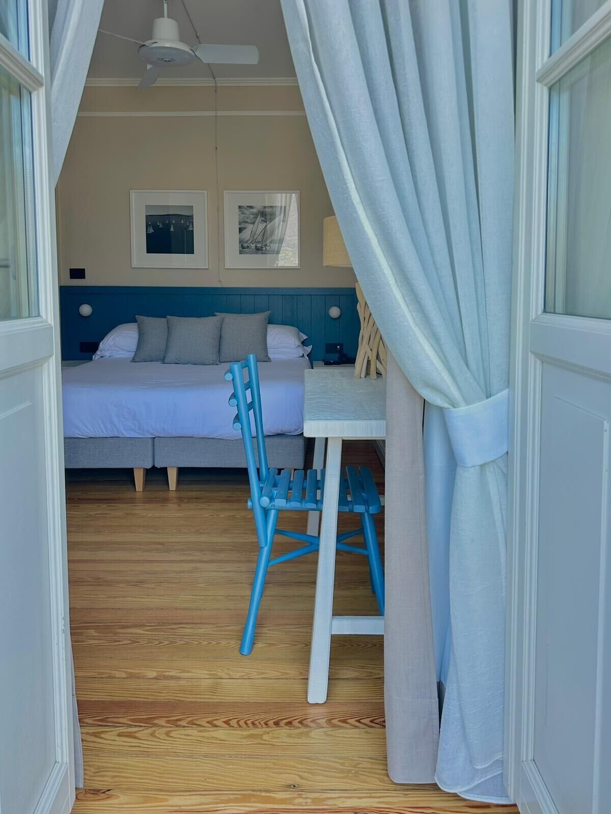 A room with a bed, a table, and a chair.