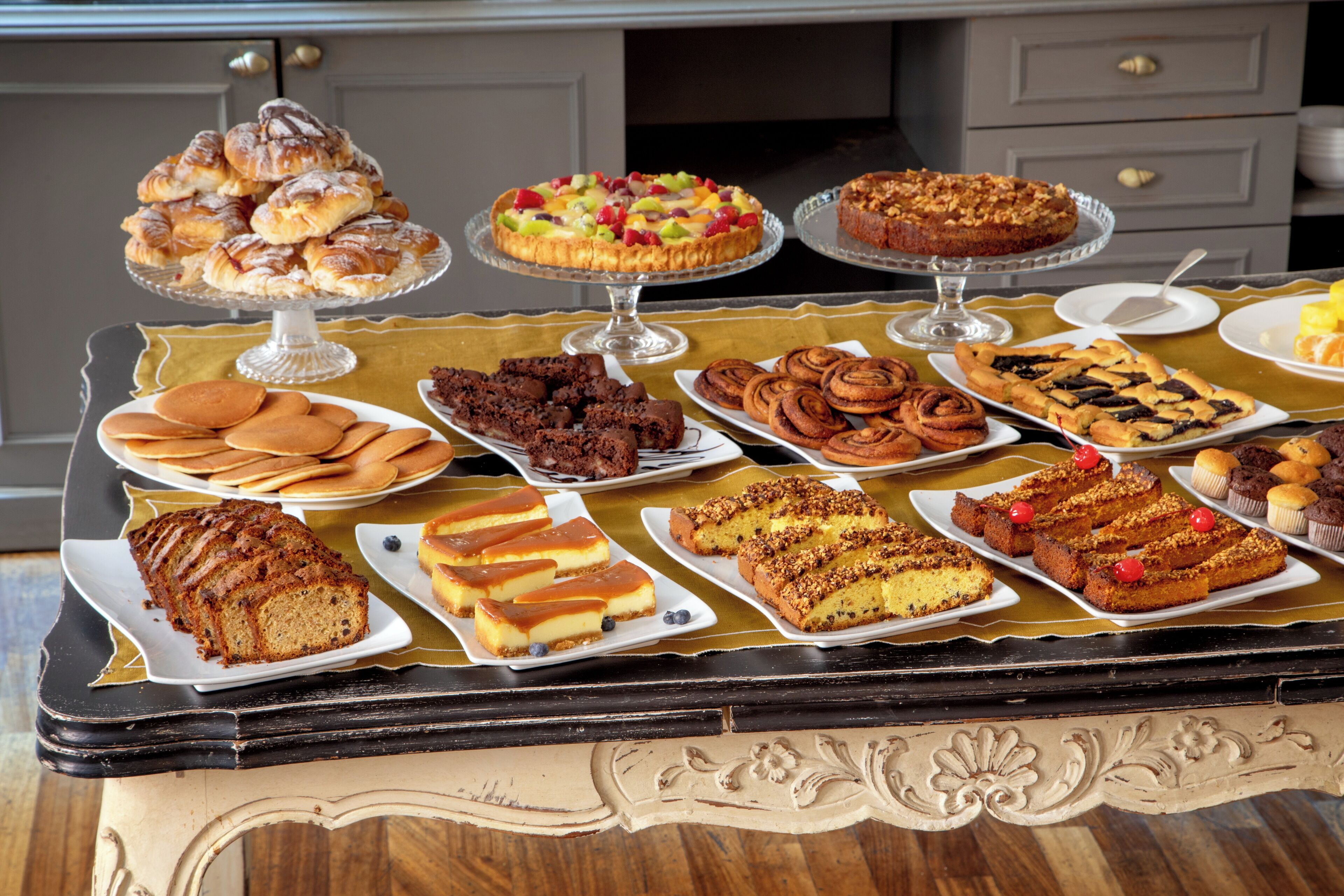 A table with various desserts and pastries.