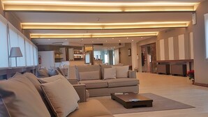A spacious living area with a large sofa set, a coffee table, and a fireplace. - Plus Welcome Milano (Milan)
