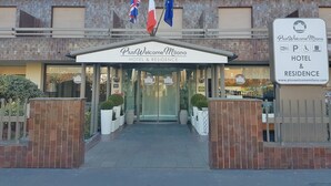 A hotel entrance with a sign reading "PlusWelcome Milano Hotel & Residence". - Plus Welcome Milano (Milan)