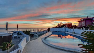 Seasonal outdoor pool, open 9 AM to 7 PM, pool umbrellas