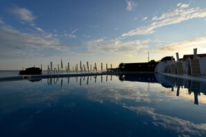 Seasonal outdoor pool, open 9 AM to 7 PM, pool umbrellas, pool loungers