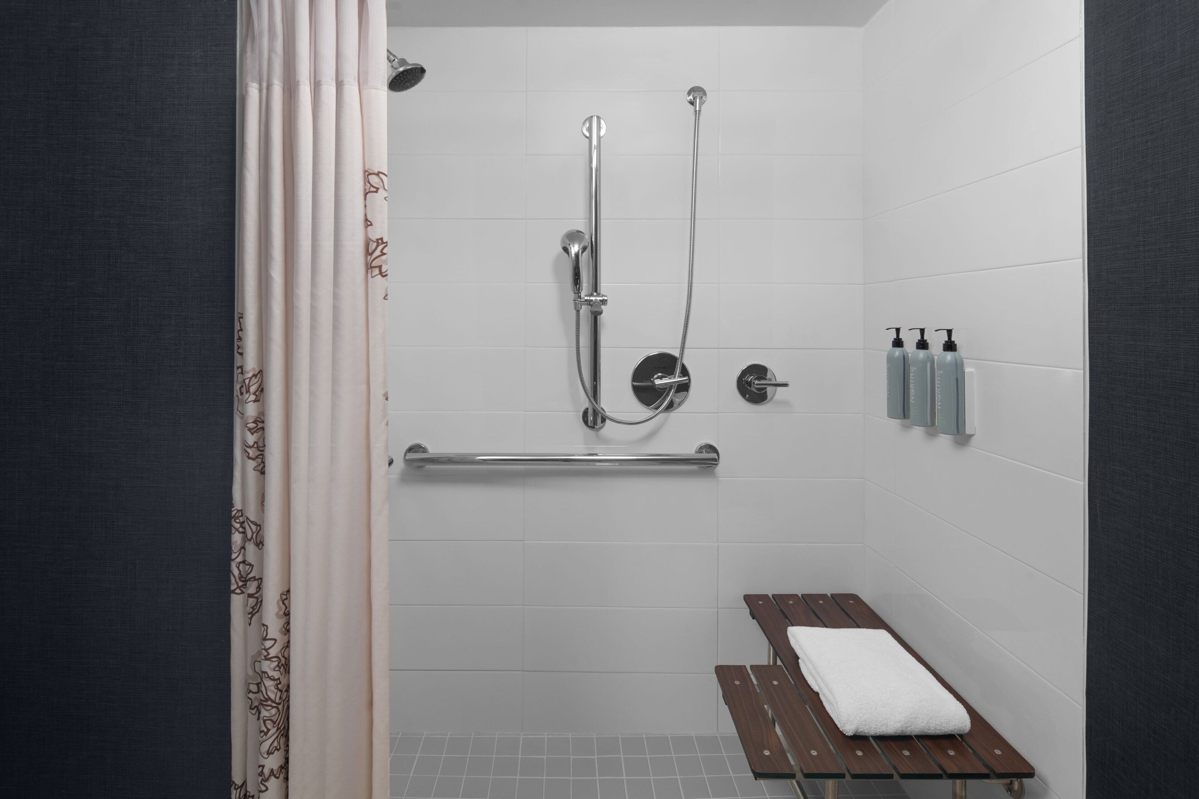 combined shower/bathtub, designer toiletries, hair dryer, towels