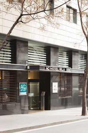 A modern hotel facade with a sign reading "AC HOTEL IRLA". - AC Hotel Irla by Marriott (Barcelona)