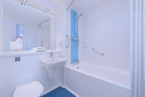 A bathroom with a white sink, toilet, and bathtub. - Travelodge Derby Cricket Ground (Derby)