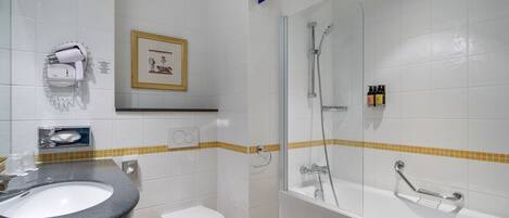 A bathroom with a sink, toilet, shower, and a towel rack.