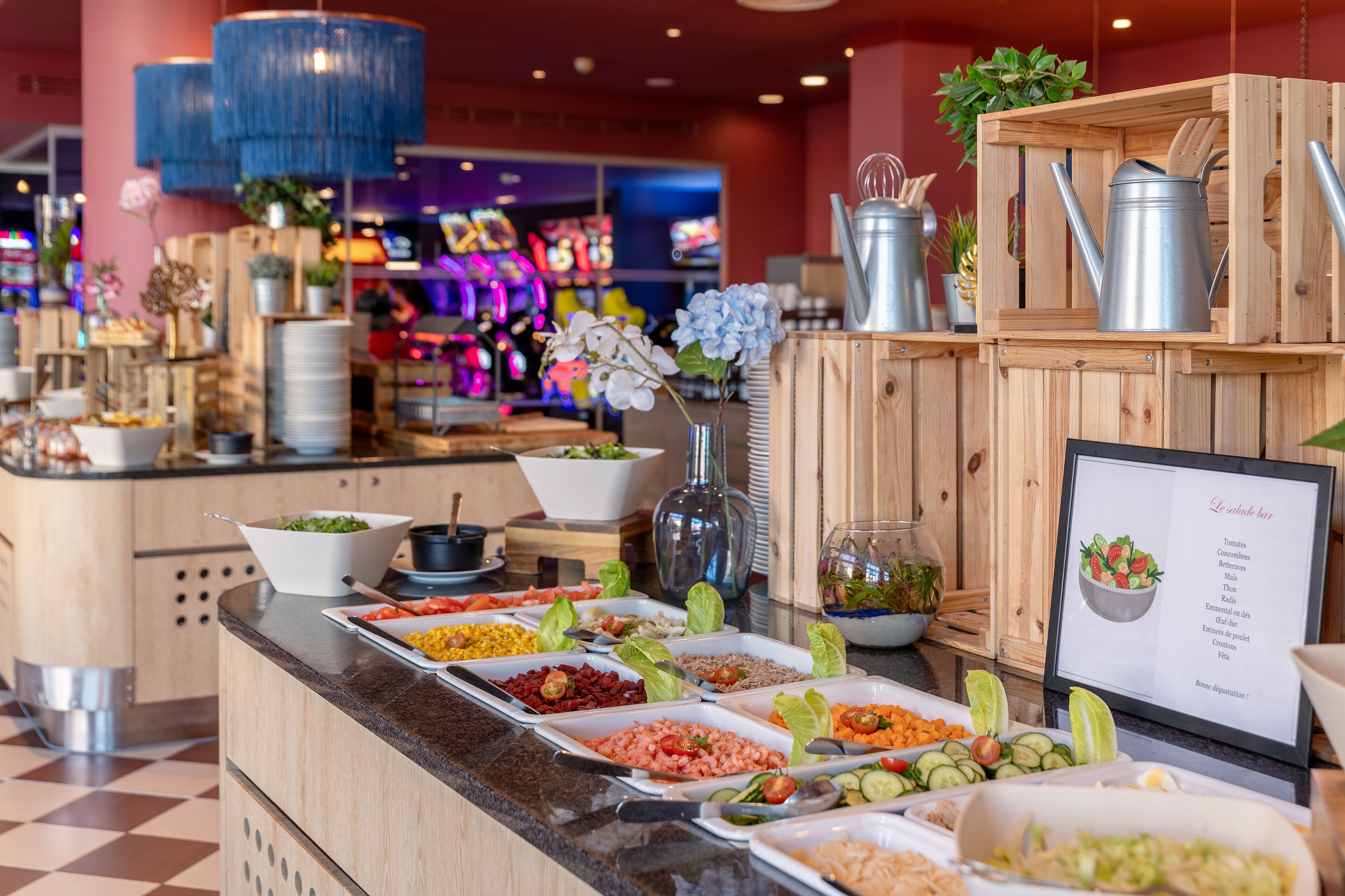 A buffet with various food items and a menu board.