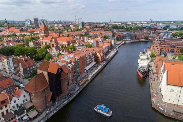 A river with a boat, surrounded by historic buildings and a prominent church.