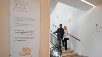 A staircase with a sign about Krumlov and gingerbread.