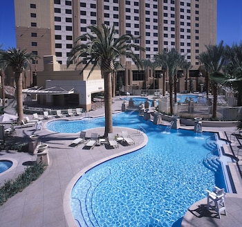 A poolside area with lounge chairs and a fire pit. at Hilton Grand Vacations Club on the Las Vegas Strip