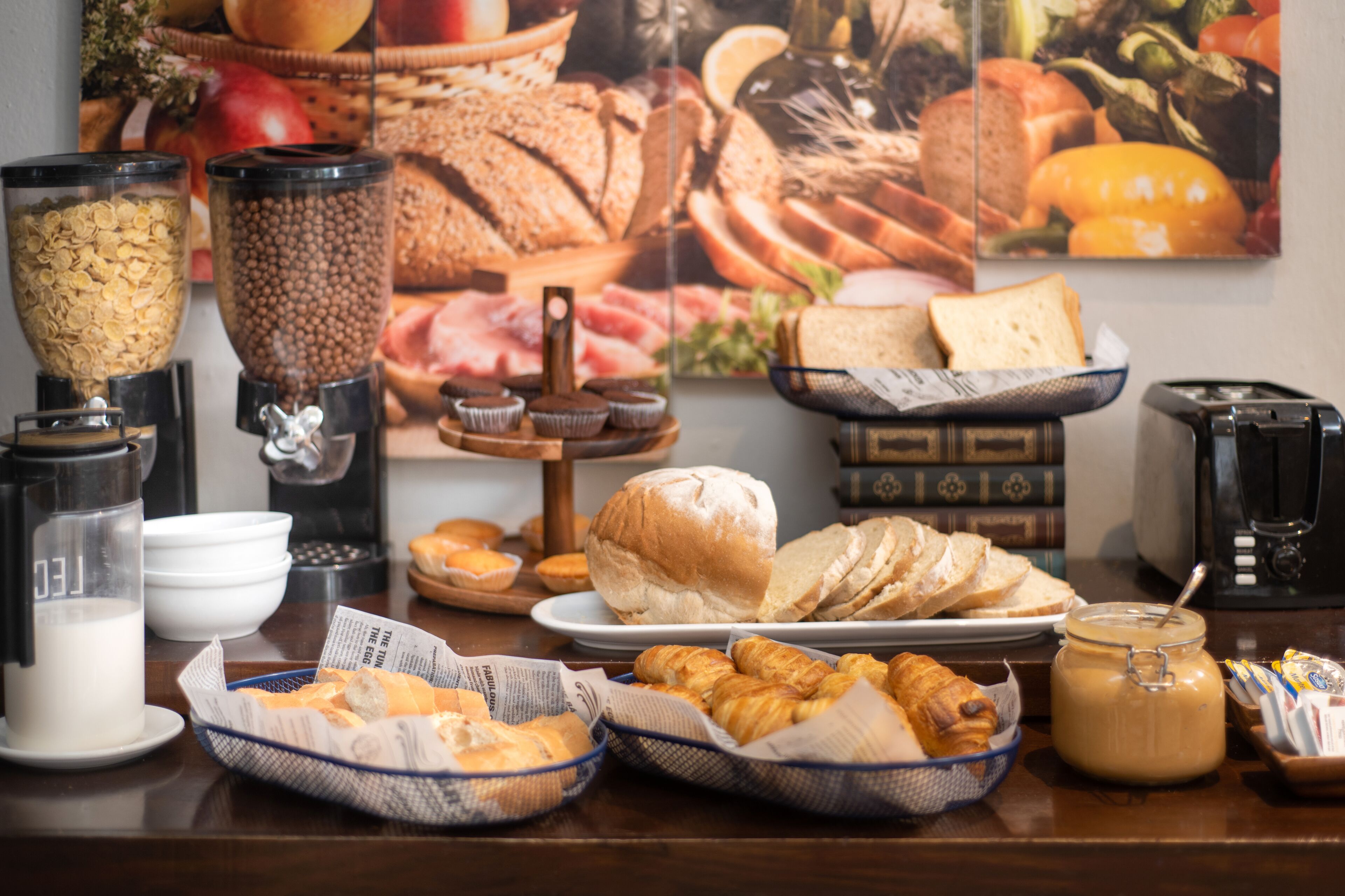 A breakfast buffet with various food items and beverages.