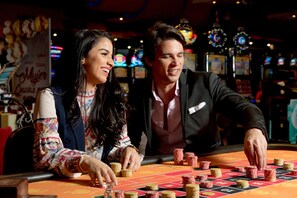 Experience the excitement of the casino floor, where roulette and slot machines come alive.