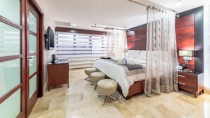 A modern bedroom with a bed, bedside table, lamp, and a view of the outside. - Hodelpa Gran Almirante Hotel & Casino (Santiago de los Caballeros)
