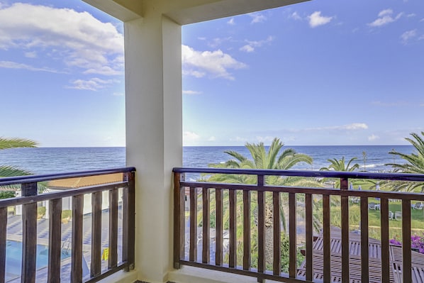 Enjoy the ocean view from this balcony overlooking the pool.