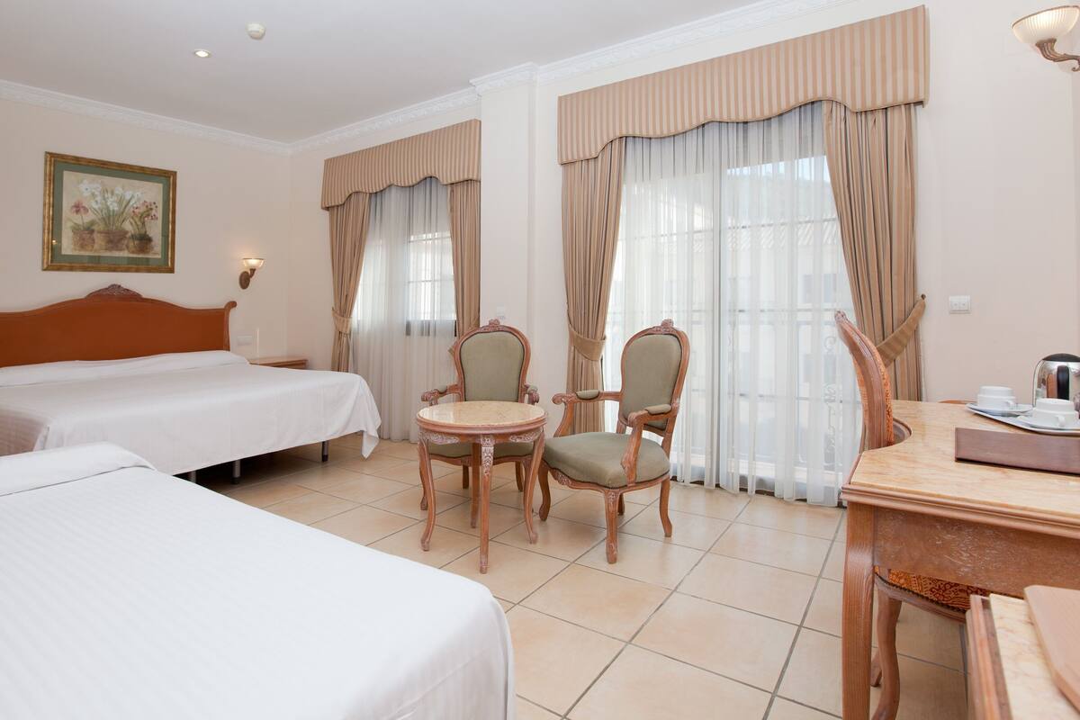 Standard Triple Room | Minibar, in-room safe, desk, iron/ironing board