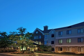 A multi-story hotel with a stone facade, large windows, and a well-maintained garden. - Staybridge Suites, Lincolnshire by IHG (Lincolnshire)
