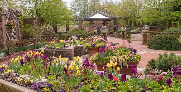 A garden with a gazebo, various flower beds, and a brick pathway. - Staybridge Suites Chicago - Glenview by IHG (Glenview)
