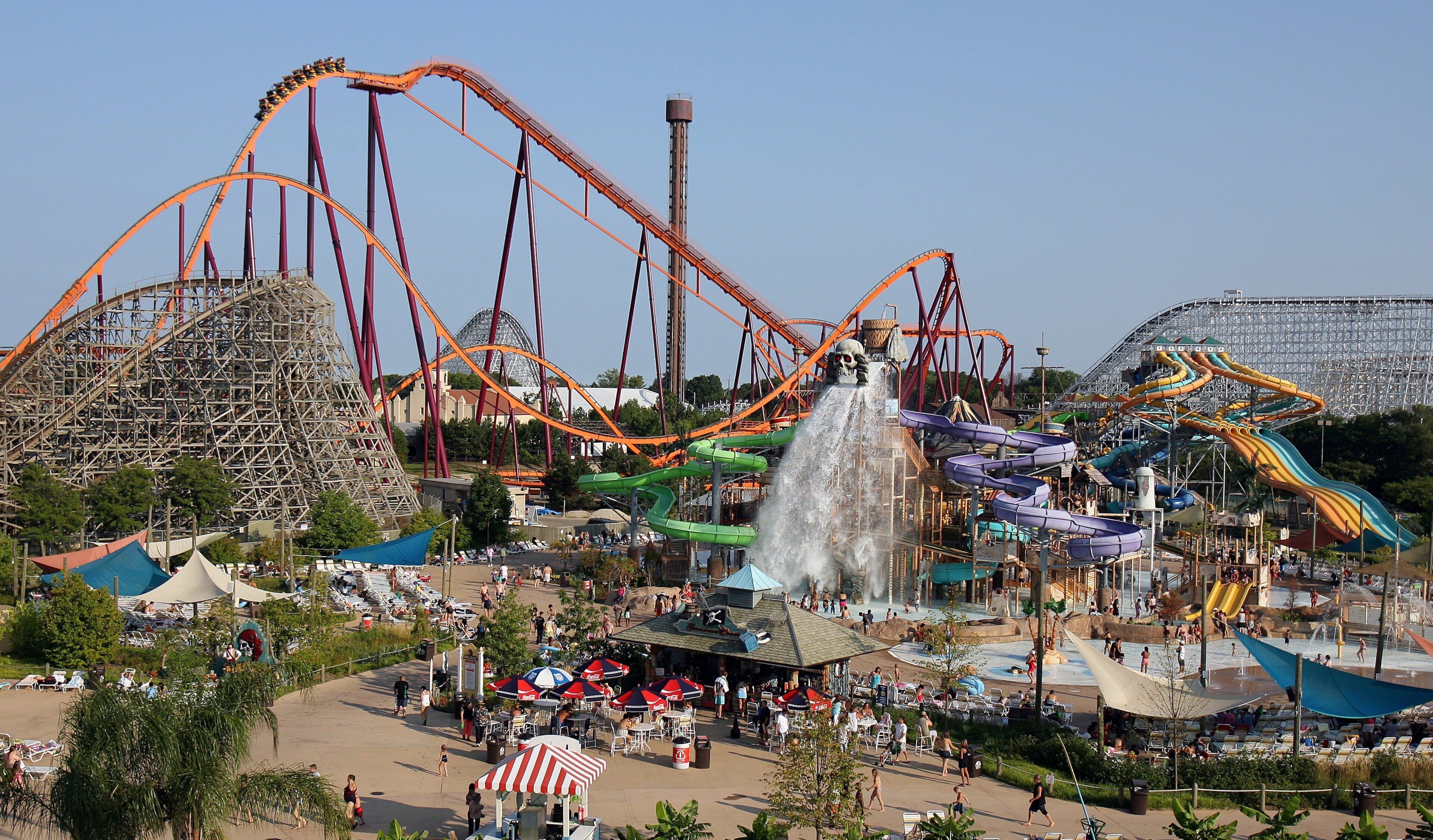 A theme park with roller coasters, water slides, and a large Ferris wheel.
