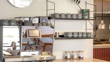 A coffee machine with a digital display, a clock, and shelves with mugs and containers.