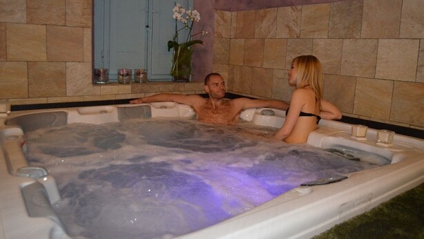 A hot tub with a man and a woman.
