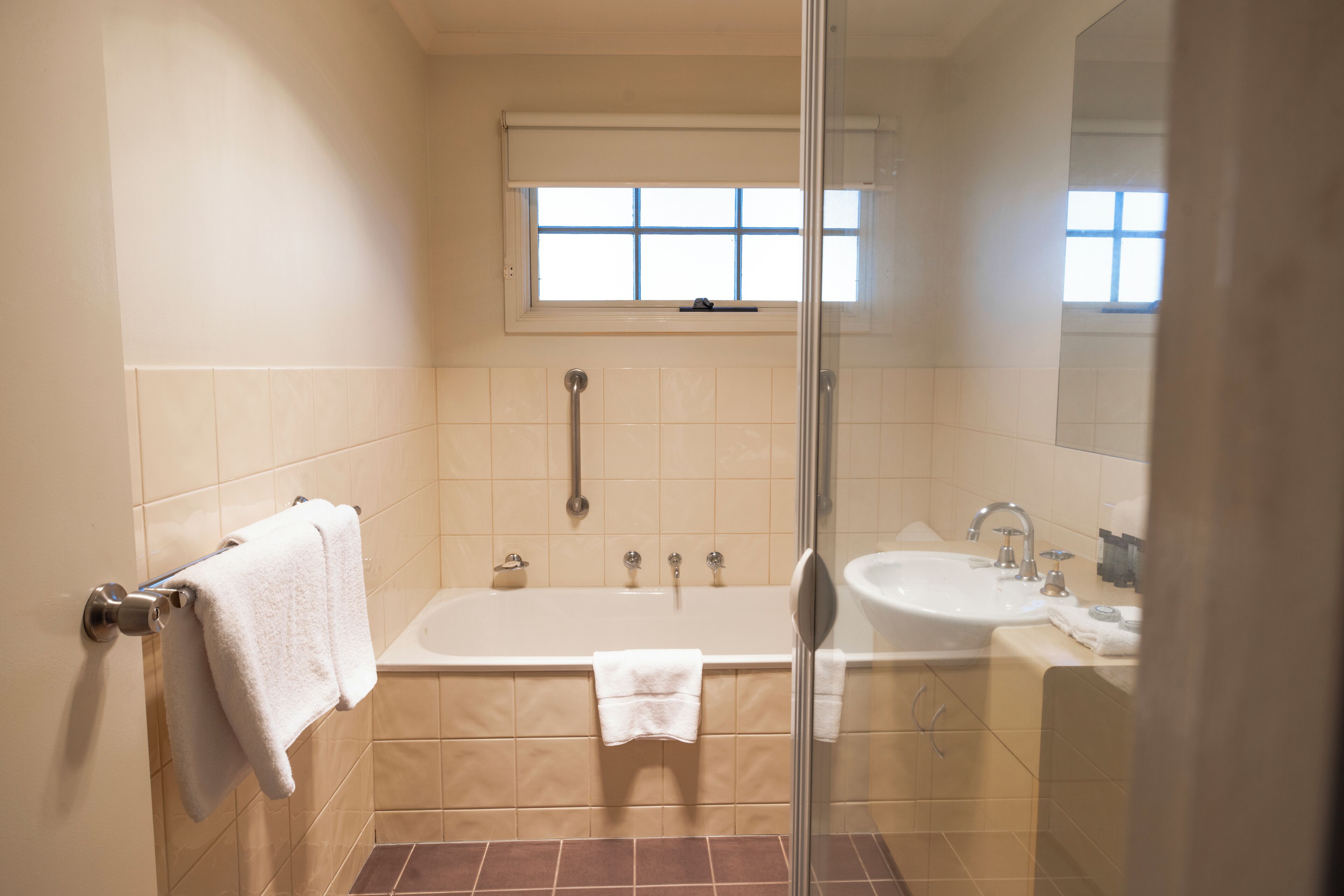A bathroom with a bathtub, a shower, and a sink.