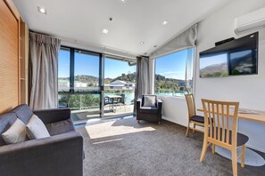 Riverfront First Floor Mezzanine Suite | Living area | 50-inch Smart TV with satellite channels, Netflix, books