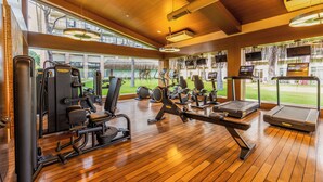 A gym with exercise equipment, large windows, and a wooden floor. - Gloria Golf Resort - All Inclusive (Serik)