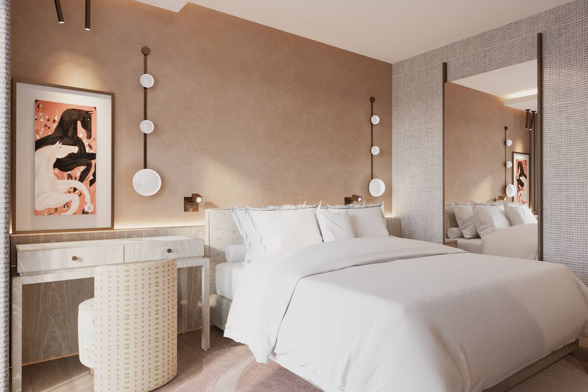 A modern bedroom with a large bed, a bedside table, a mirror, and wall-mounted lighting.