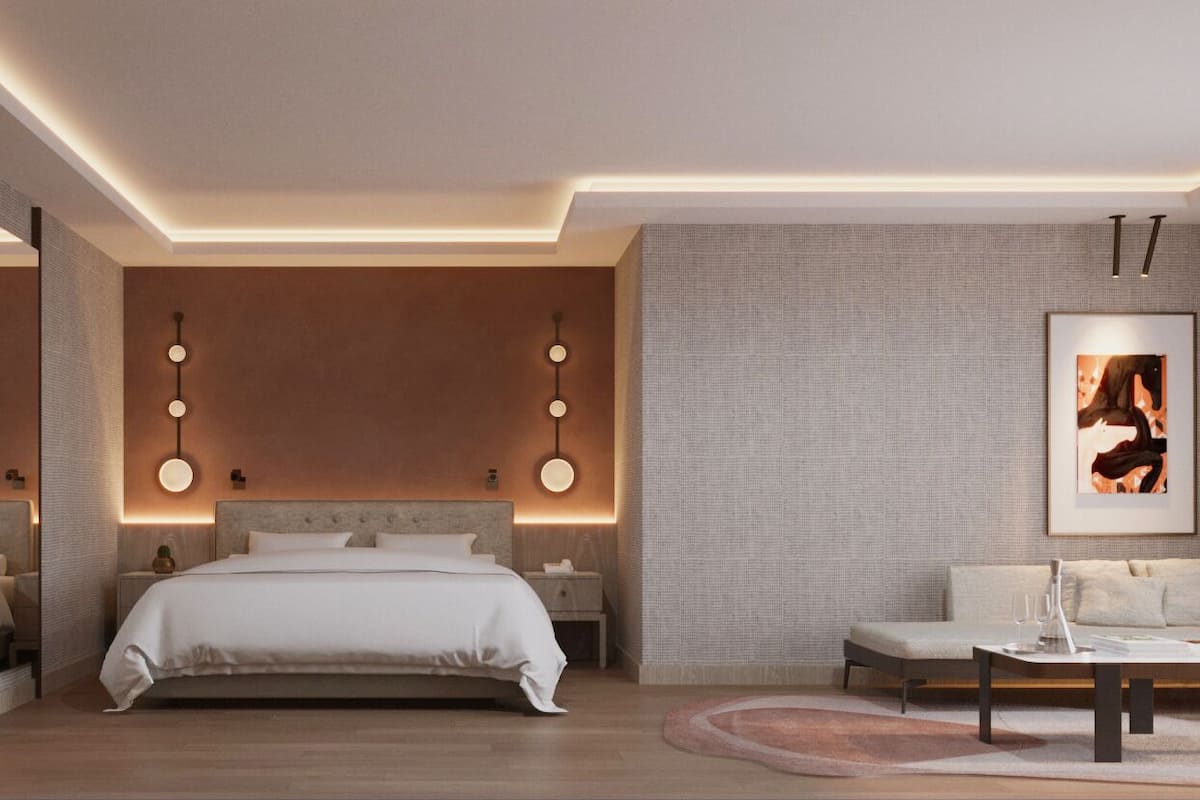 A modern bedroom with a bed, bedside tables, a sofa, and a coffee table.