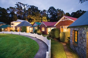 Village Waterfront Cottage | Front of property - evening/night