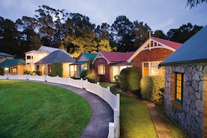 Village Waterfront Cottage | Front of property – evening/night