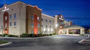 A hotel with a modern design, multiple floors, and a well-lit entrance. - Best Western Plus Delta Inn & Suites (Oakley)