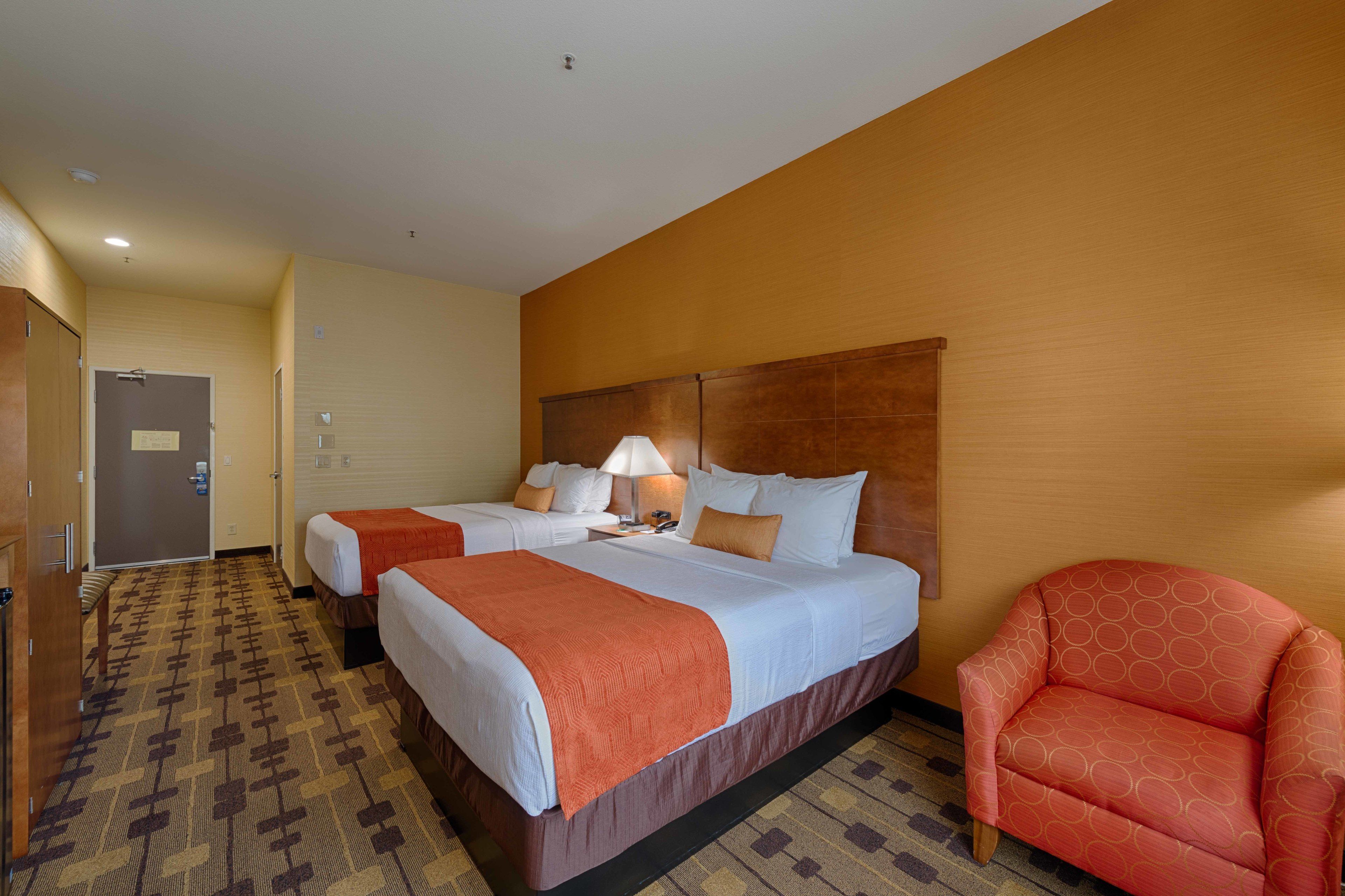 pillow-top beds, desk, laptop workspace, blackout curtains