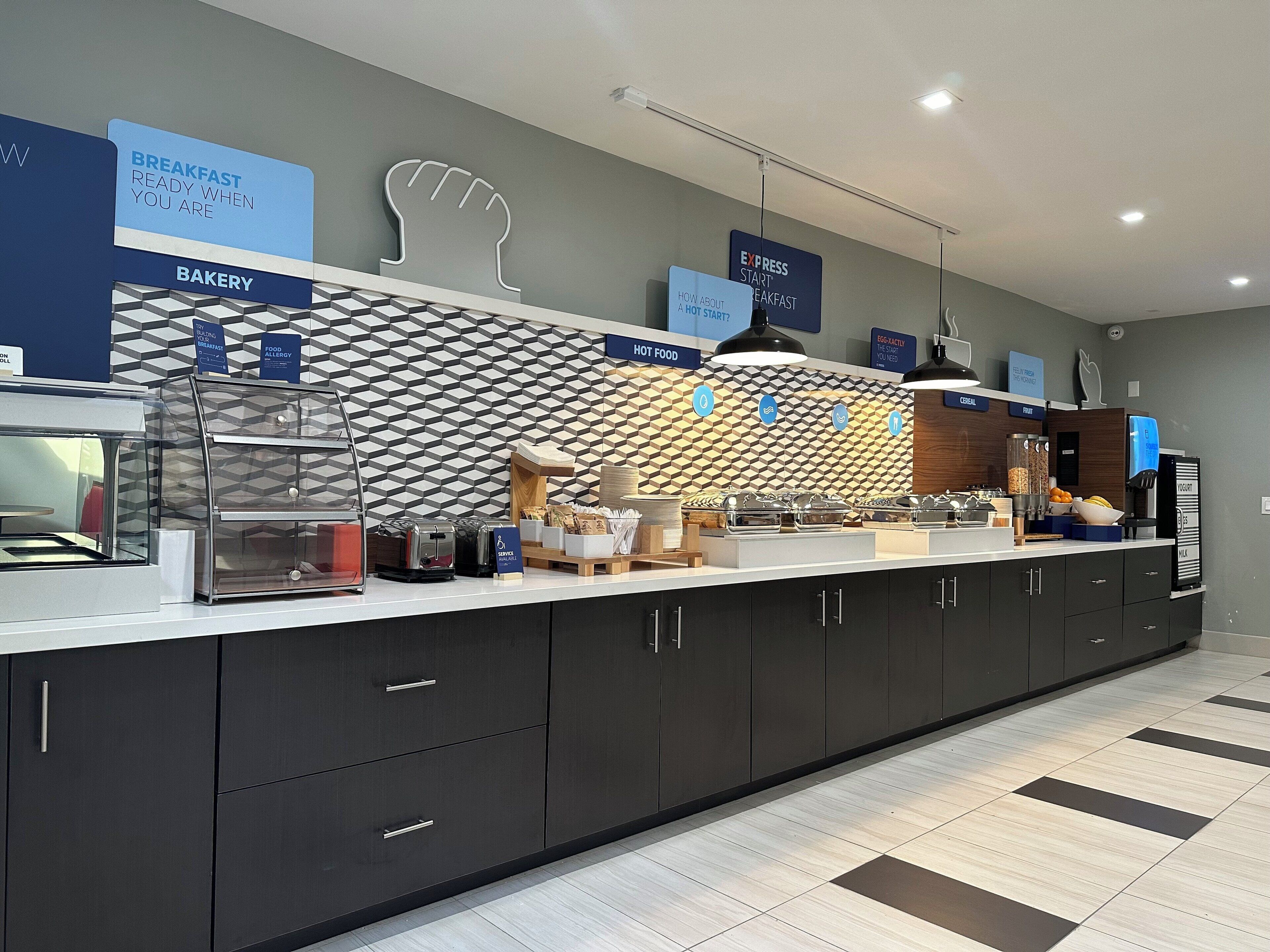 A modern breakfast area with a bakery section, self-service food station, and express breakfast sign.