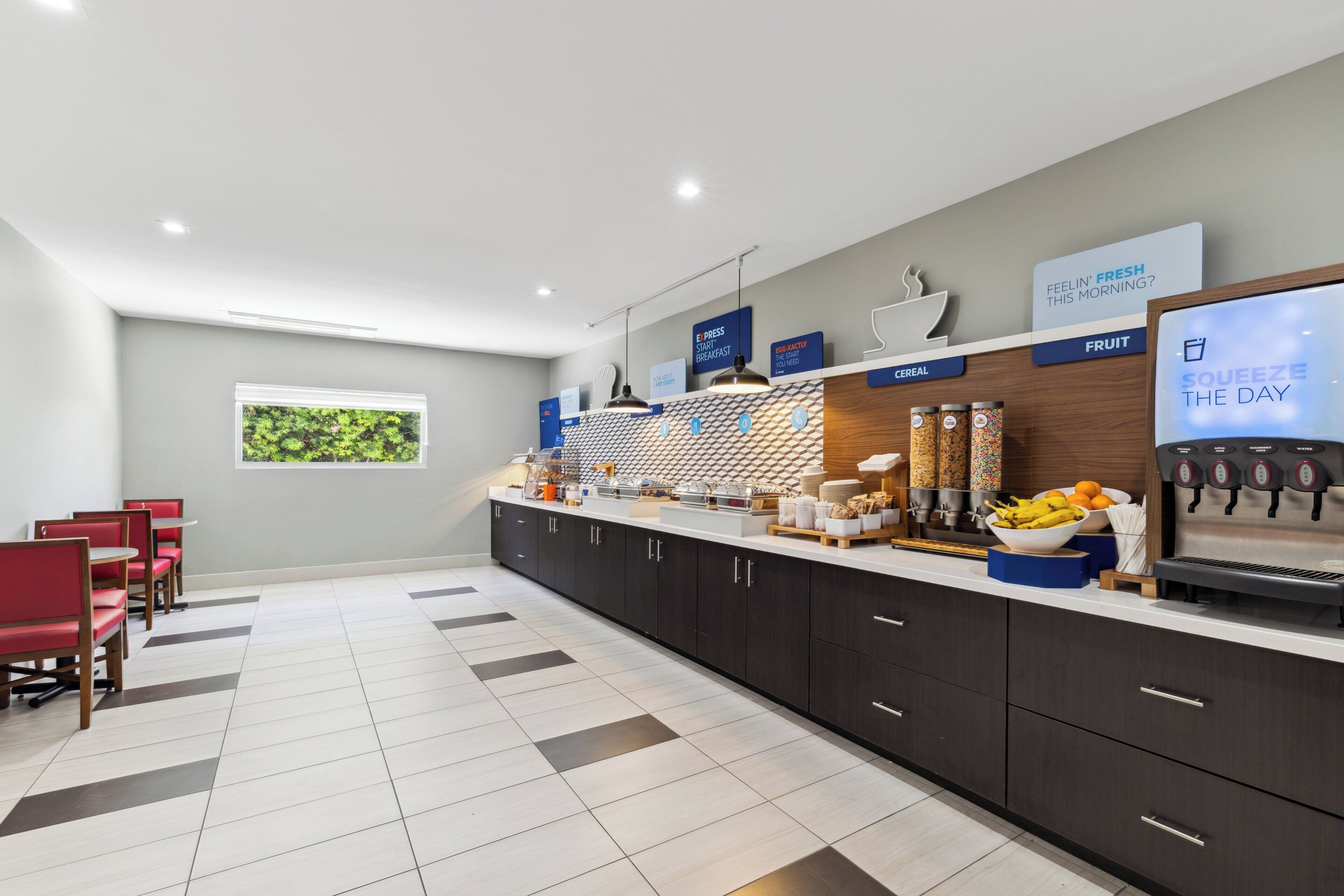 A modern breakfast area with a counter, seating, and a window with a view.