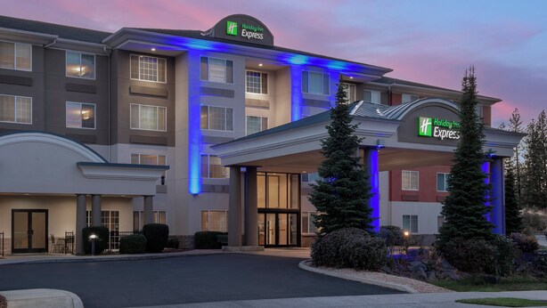 A Holiday Inn Express hotel with a modern facade, multiple entry points, and a landscaped entrance area. - Holiday Inn Express Spokane Airport by IHG (Spokane)