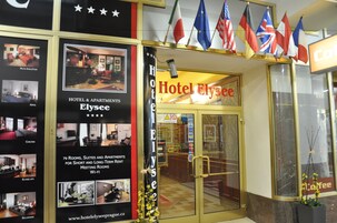 Fachada do Hotel Elysee, com placa indicando 79 quartos, suítes e apartamentos para aluguel de curta e longa duração.