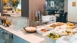 A buffet setup with various food items and beverages. - Hotel Elysee (Prague)