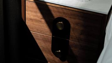 A wooden drawer with a marble countertop above it.