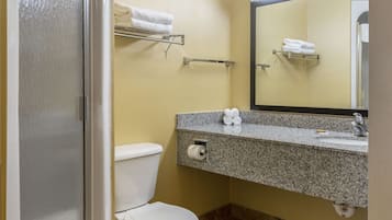 A bathroom with a toilet, sink, and towel rack.