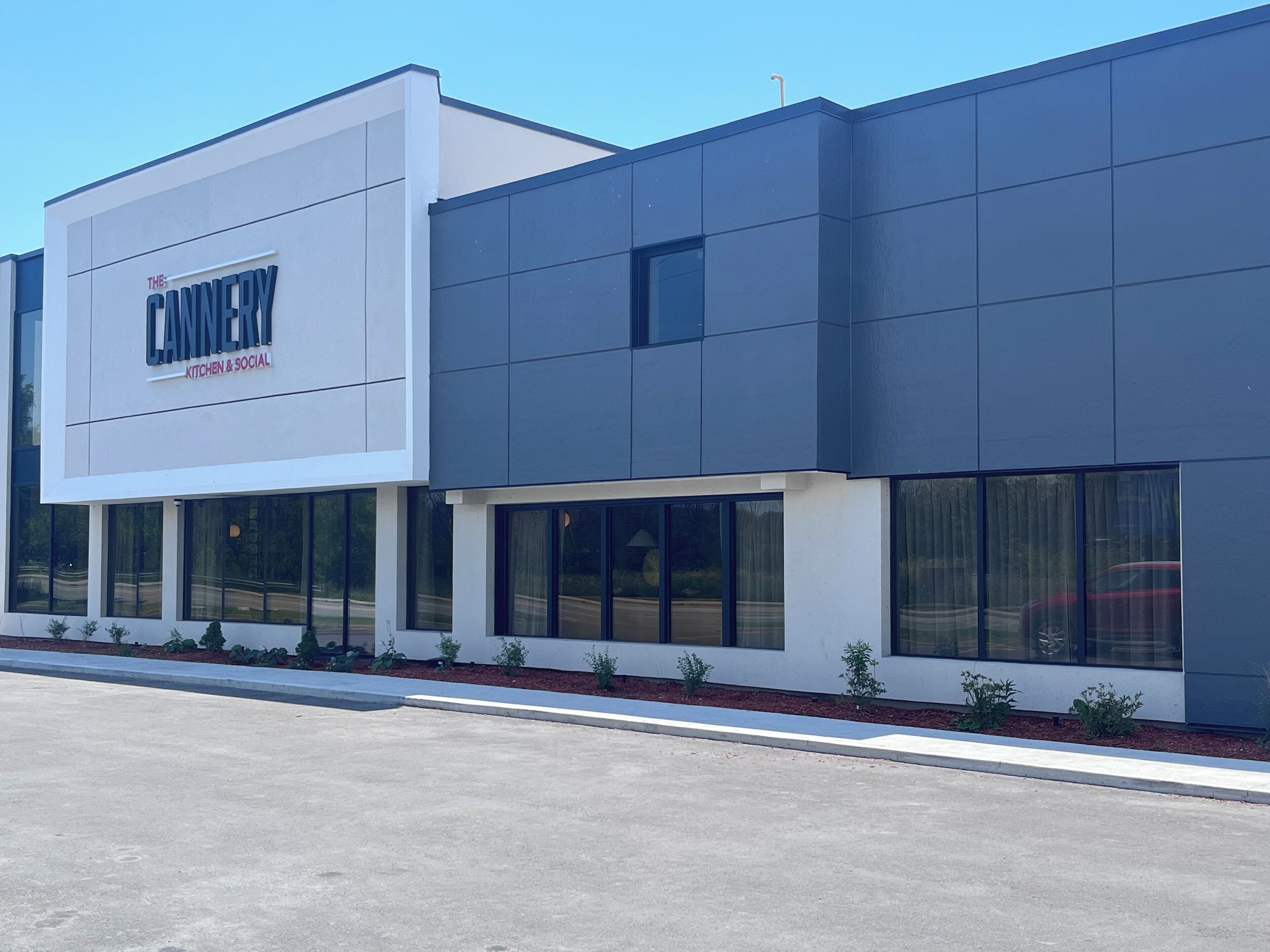 A modern building with a sign reading "The Cannery" and "Kitchen & Social."
