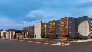 A modern hotel with multiple floors, a covered entrance, and landscaped areas. - DoubleTree by Hilton Kingston (Kingston)