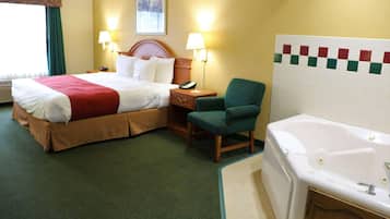 A hotel room with a bed, a chair, a desk with a lamp, a telephone, and a bathtub.