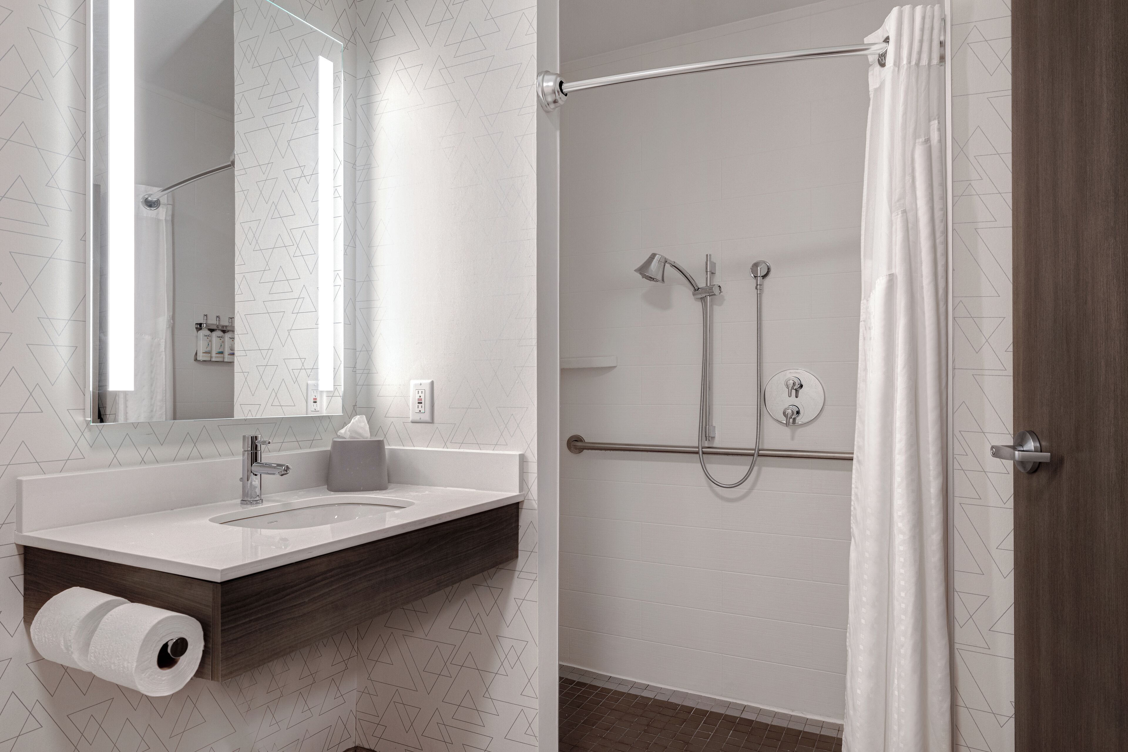 Ein modernes Badezimmer mit Dusche, Waschbecken und Toilette.