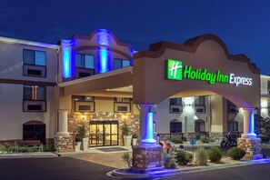 A Holiday Inn Express hotel with a prominent entrance, stone pillars, and a well-lit facade. - Holiday Inn Express & Suites Moab by IHG (Moab)