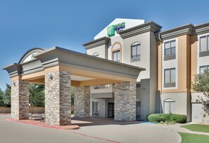 A Holiday Inn Express hotel with a covered entrance, stone pillars, and a clear blue sky. - Holiday Inn Express Hotel & Suites Dallas - Duncanville by IHG (Duncanville)