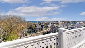 A residential area with houses, a white fence, and a clear sky. - Nantucket Resort Collection (Nantucket)
